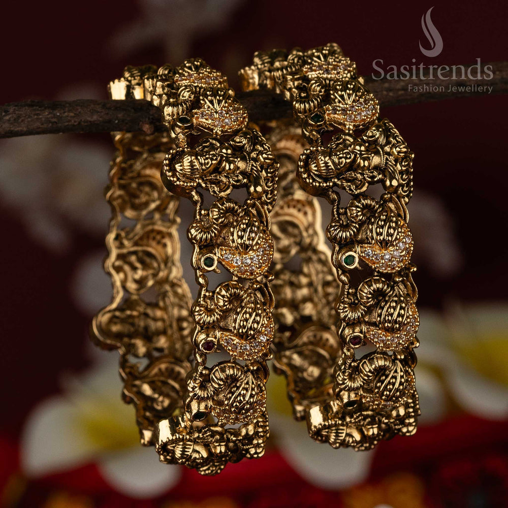 Bridal temple bangles adorned with sacred swan and Lakshmi motifs in a matte gold finish, beautifully enhanced by multi-colour AD stones – a radiant ethnic jewellery treasure by Sasitrends
