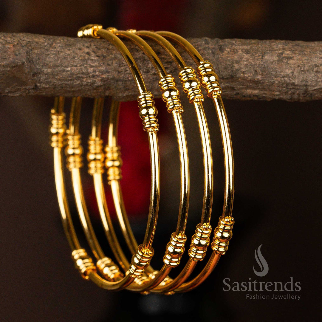 Set of four elegant micro gold-plated kada bangles with classic golden bead details