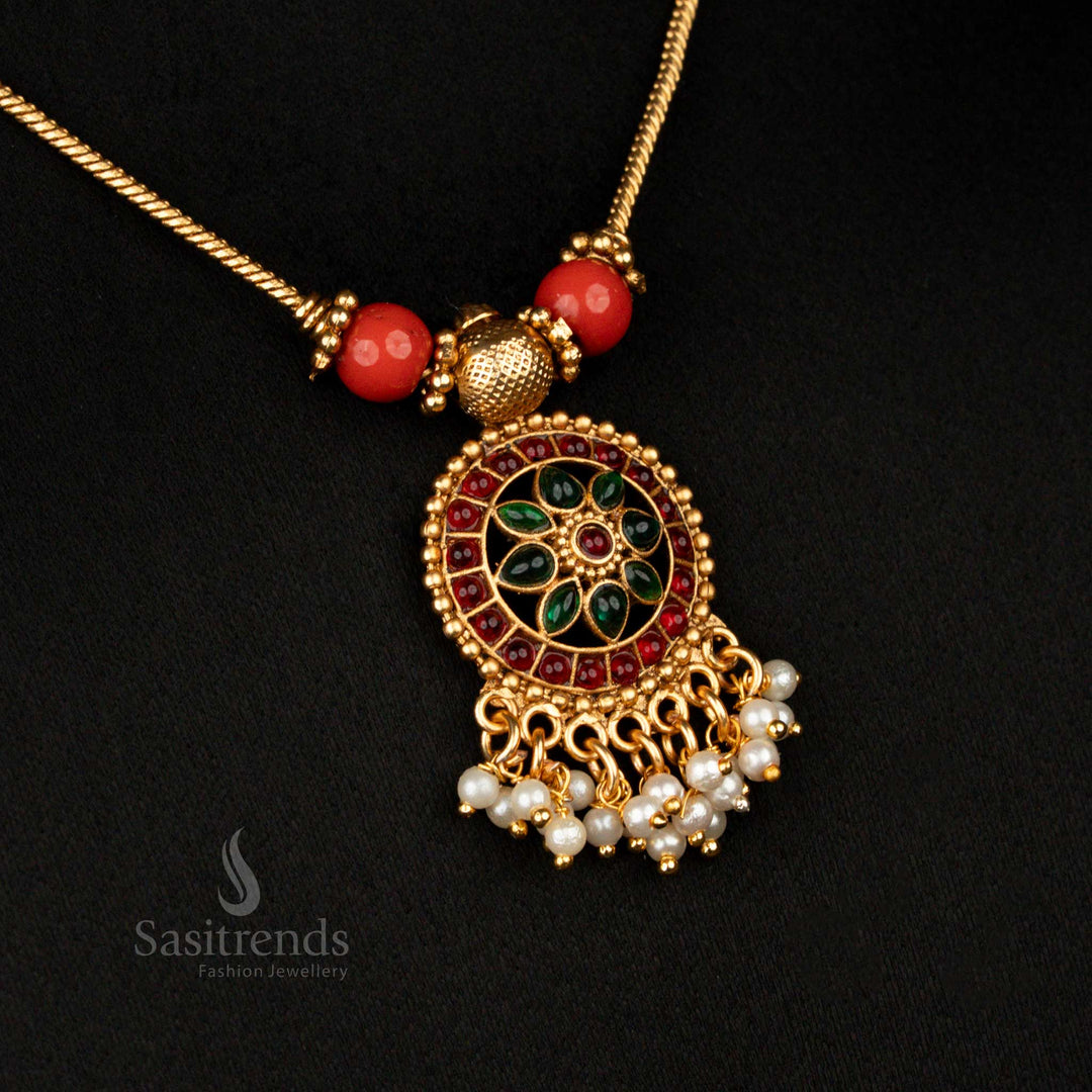 Elegant vintage-style matte gold floral necklace set with ruby-green dual stone pendant, ornate beaded design, and charming pearl drops – timeless temple jewellery for weddings and rituals – Sasitrends