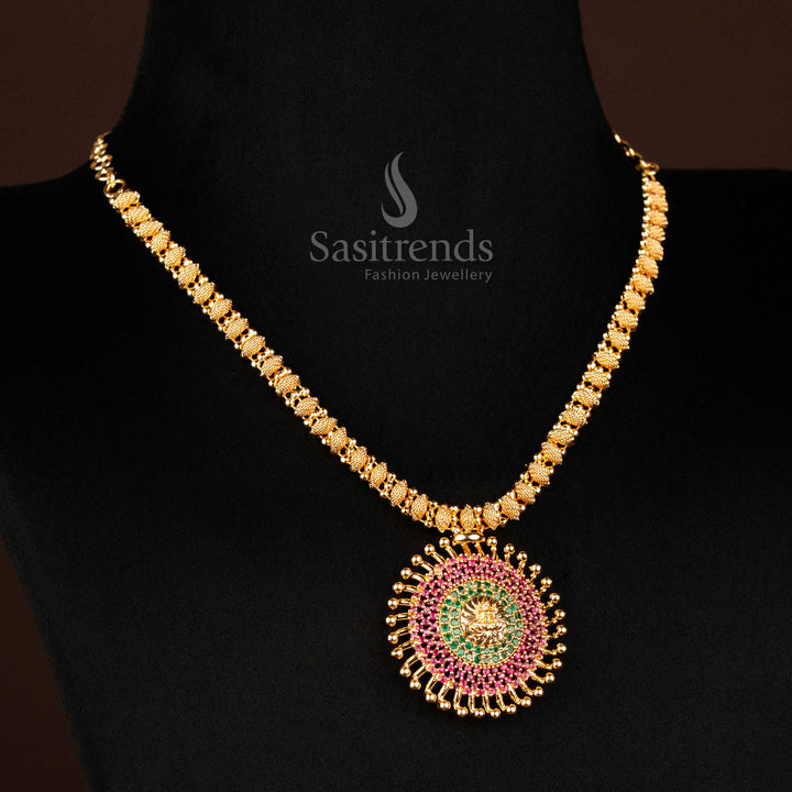 Traditional Lakshmi Sunburst pendant necklace adorned with ruby-green AD stones and micro gold-plated finish, reflecting divine grandeur and South Indian ethnic jewellery excellence – heritage creation by Sasitrends