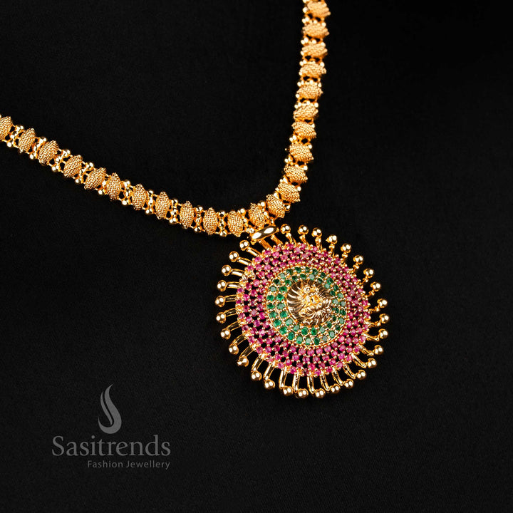 Ethnic one gram gold necklace featuring a Lakshmi goddess sunburst pendant and ruby-green accents, inspired by temple traditions and festive celebration wear – intricately crafted Indian jewellery by Sasitrends