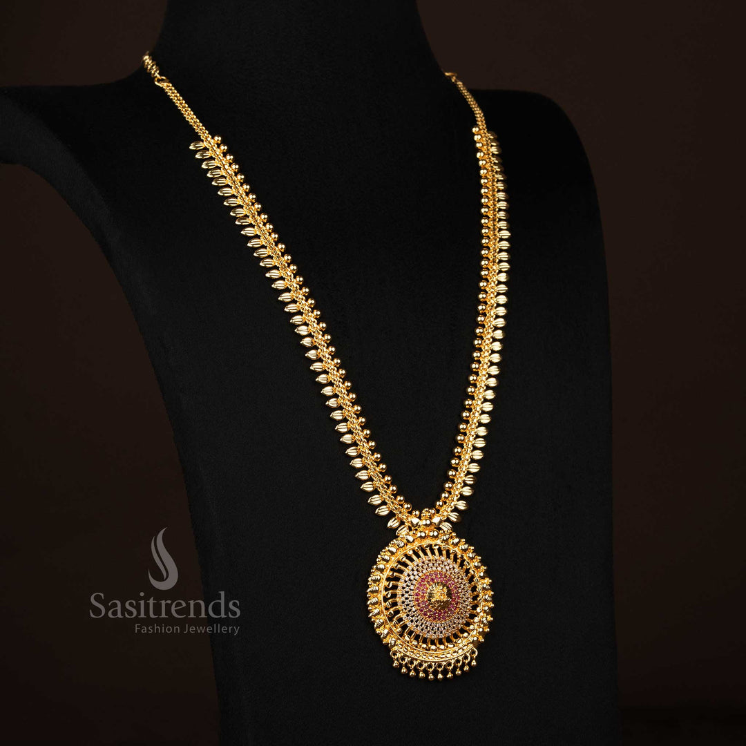 Elegant long haram necklace in white-ruby tone featuring a majestic Lakshmi pendant, micro gold plating, radiant AD accents, and intricate leaf motifs – Ideal for traditional charm and cultural finesse – Sasitrends