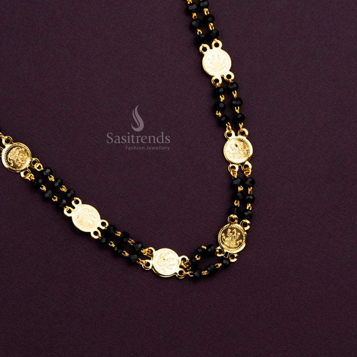Traditional South Indian temple necklace with embossed Lakshmi coins and black beads.