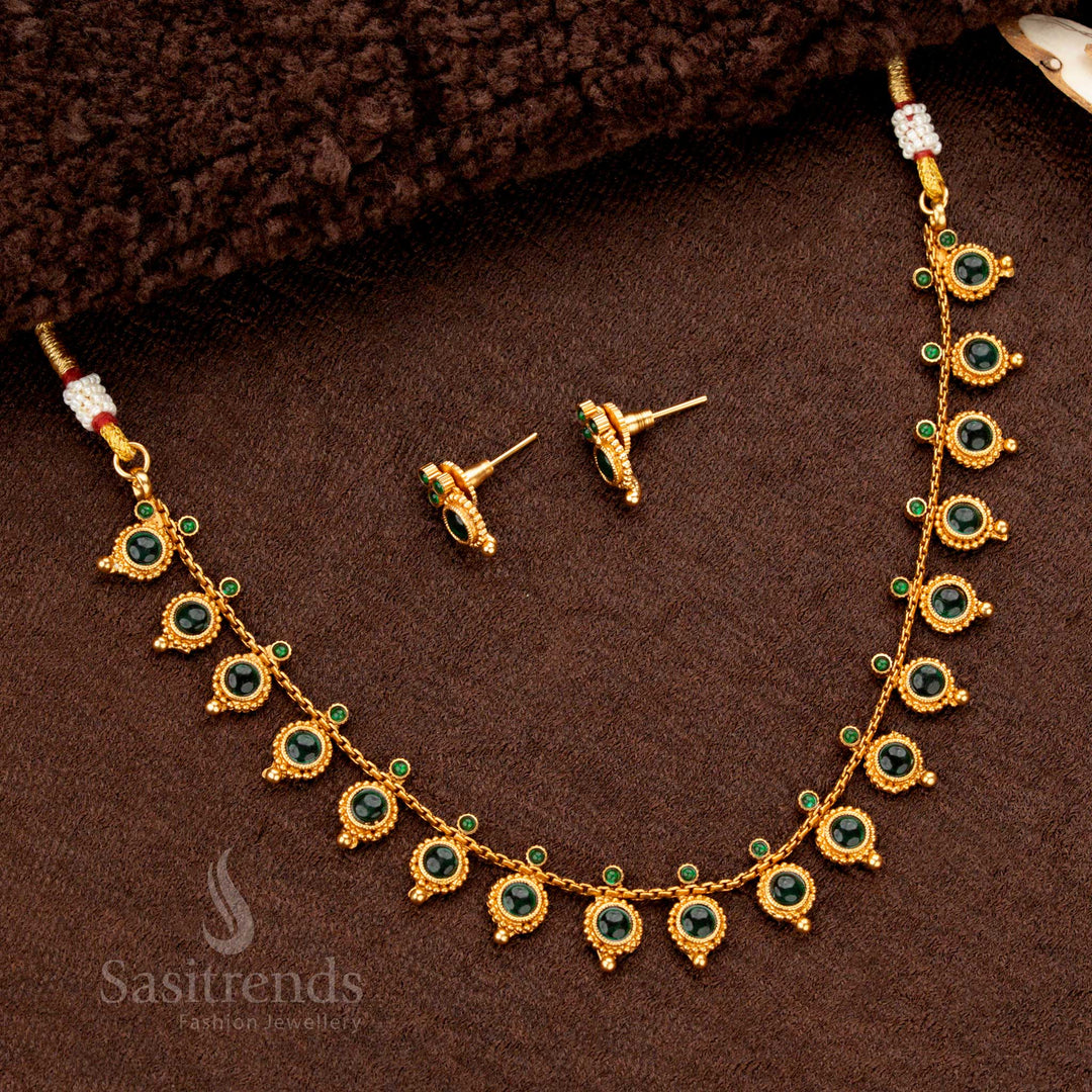 Exquisite grand matte gold-plated temple necklace set featuring hand-engraved designs, round droplet detailing, and luminous green stones for an opulent traditional appearance - Sasitrends