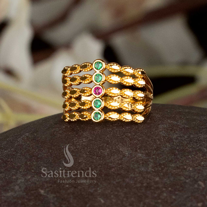 AD stone embellished micro plated gold ring in a step pattern.
