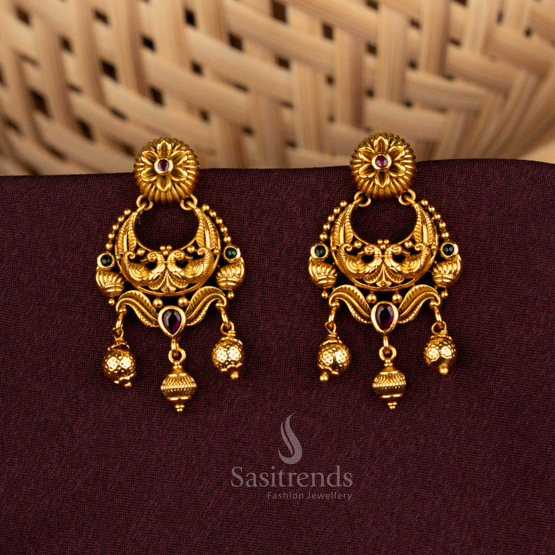 Majestic ruby green temple earrings showcasing divine peacock artistry, floral AD brilliance, matte gold elegance, and noble refinement created for splendid bridal celebrations – Sasitrends