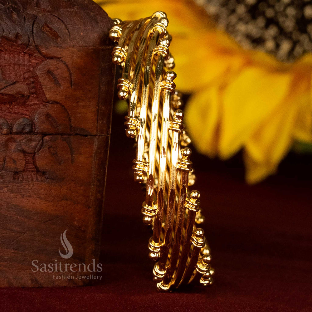 Elegant side view of a multi-layered micro gold plated bangle set, showcasing its unique design and rich finish.