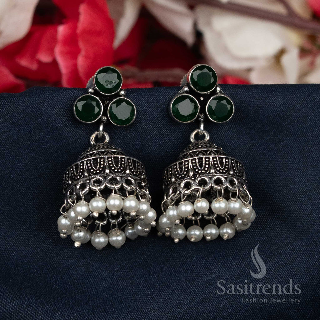 Majestic oxidised green Jhumka earrings crafted with pearl bead clusters and glittering studs – traditional luxury wear for grand celebrations and weddings – Sasitrends