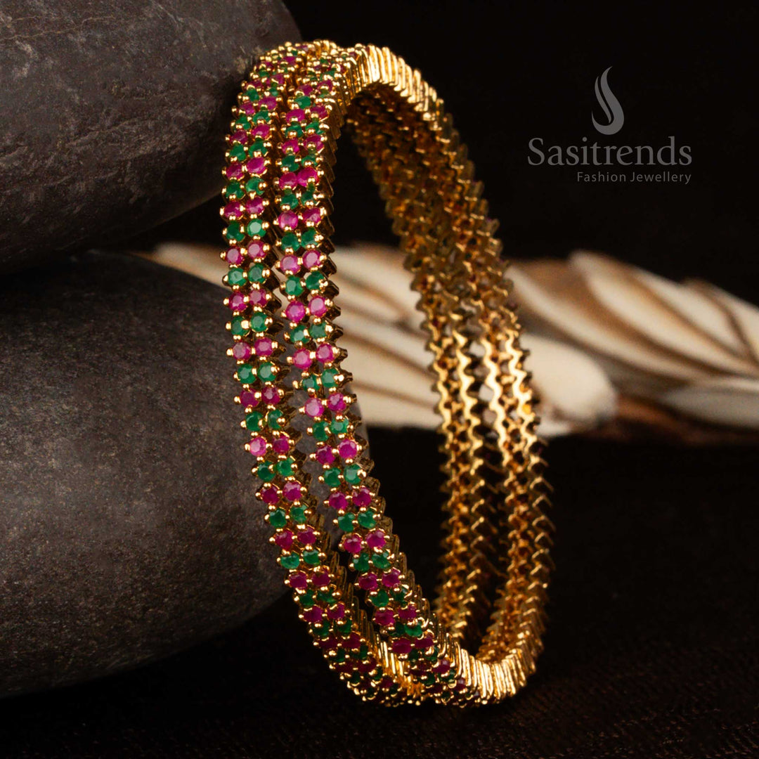 Dual-tone ruby-green American diamond two-line micro gold plated bangles with exquisite shine and timeless appeal for vibrant Indian celebrations by Sasitrends