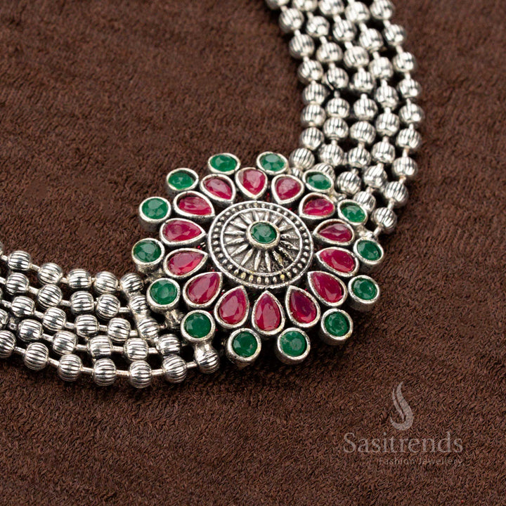 Festive oxidised German silver choker set with an enchanting floral pendant adorned with ruby and green stones, a striking choice for Navaratri, traditional attire, and grand occasions - Sasitrends
