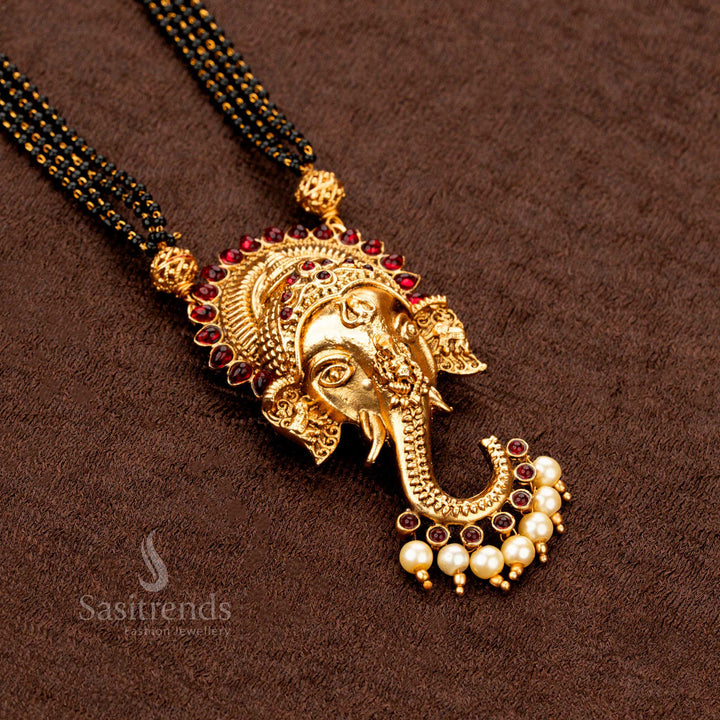 Ethnic Indian matte gold mangalsutra with a majestic Ganesh pendant and rich ruby red stone embellishment, a classic bridal jewellery piece radiating cultural beauty  - Sasitrends