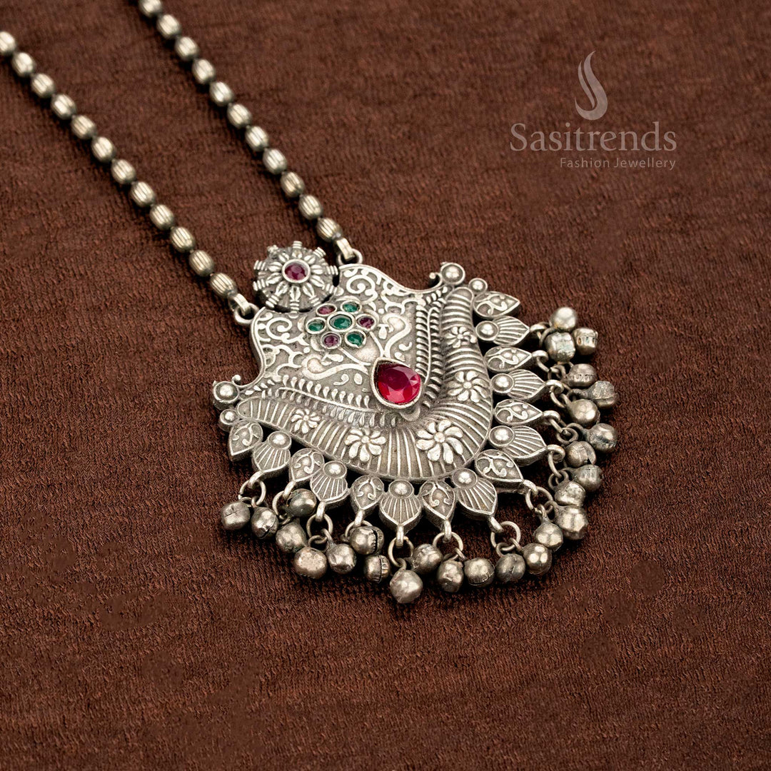 Oxidised necklace in German silver with a ruby-green duo stone pendant, intricate floral etchings, and antique ball drops – a heritage-style jewellery creation by Sasitrends