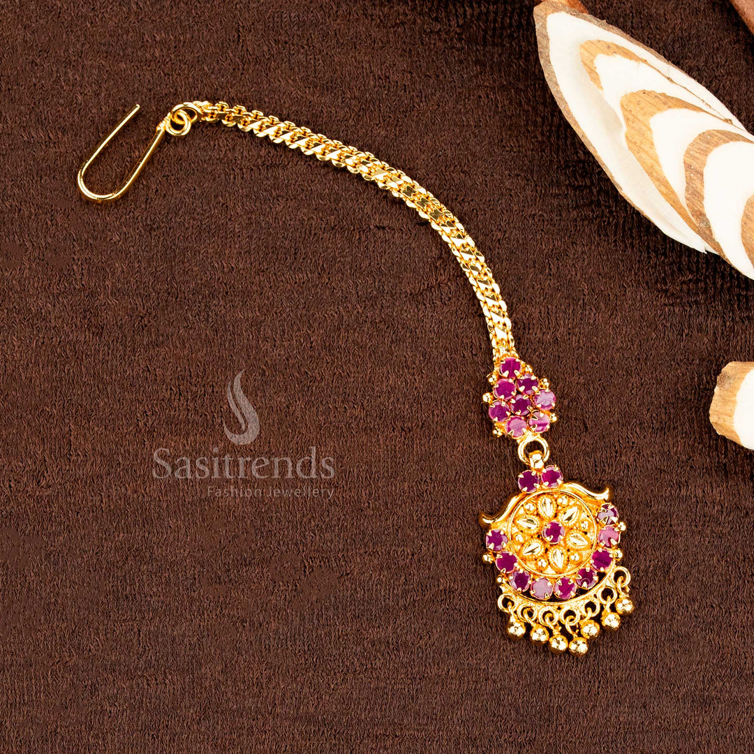 Heritage-inspired ruby AD floral tikka with swinging ball, a micro gold polished headpiece created for classic ethnic jewellery lovers and traditional festive styling – sasitrends
