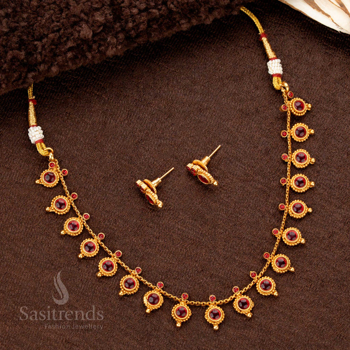 A timeless antique-style temple necklace set in matte gold, adorned with rich engravings, delicate droplet accents, and glowing ruby stones, bringing a regal aura to ethnic ensembles - Sasitrends
