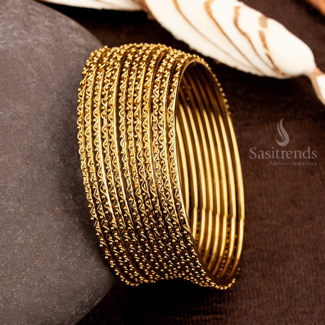 Classic Indian tradition-inspired antique bangles, set of 12, adorned with intricate carvings and grand ethnic appeal, designed for bridal beauty and festive splendour by Sasitrends