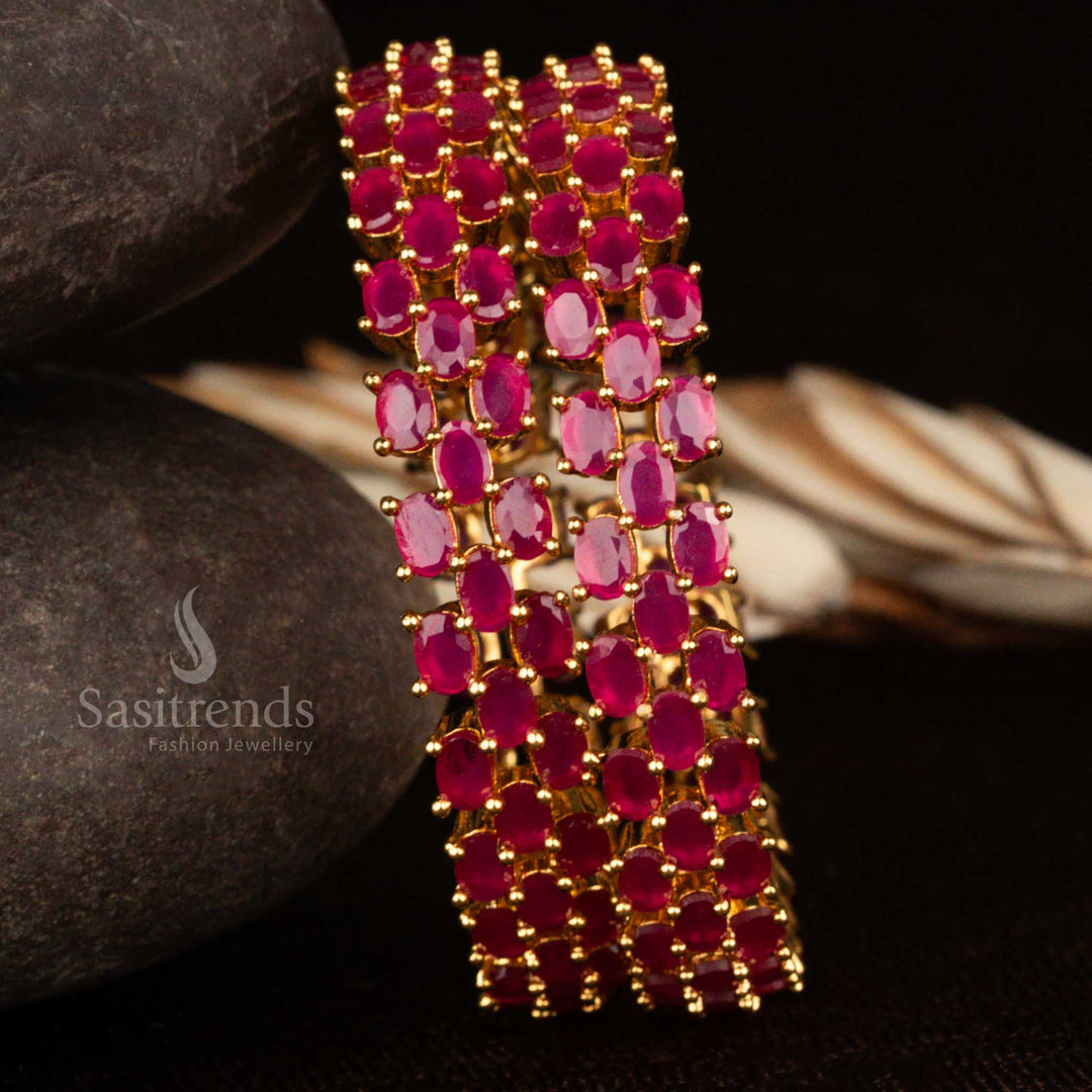 Micro gold plated CZ bangle set embellished with deep ruby American diamond stones and intricate floral carving – a richly adorned traditional jewellery piece for graceful festive wear by Sasitrends