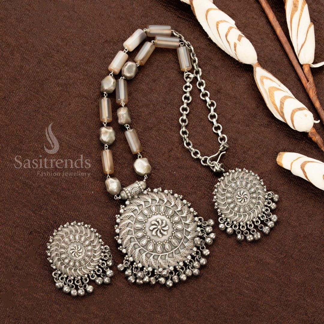 Vintage oxidised silver statement necklace, featuring burnished brown gemstones, a round floral pendant, and classic earrings, perfect for elevating traditional saree jewellery looks - Sasitrends