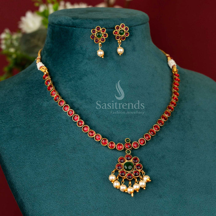 Temple-style pearl embellished necklace with ruby-green stones and matte gold finish – a bold and elegant jewellery pick – sasitrends
