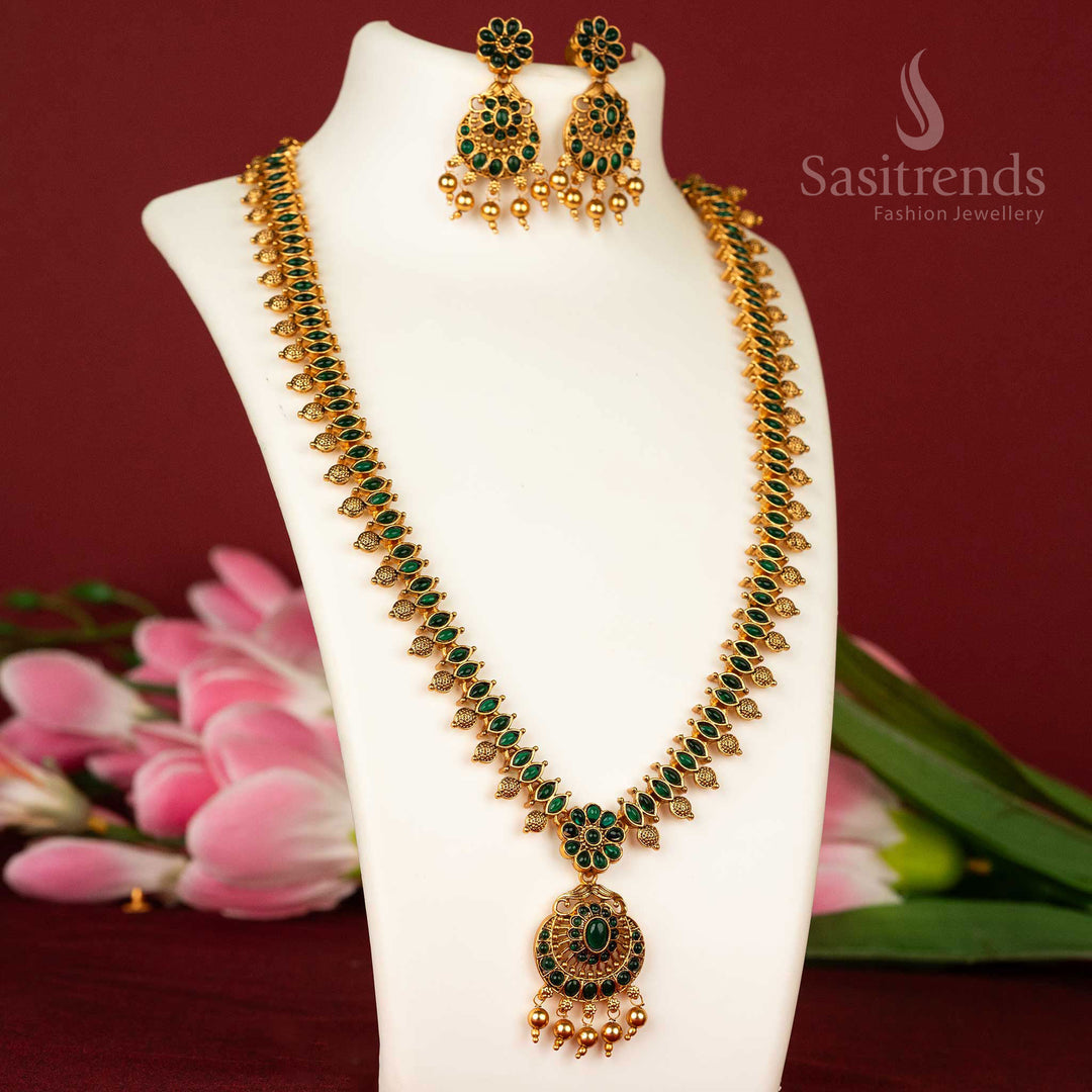Divine temple style long haram necklace with green stones and floral matte gold detailing – a graceful jewellery piece – sasitrends