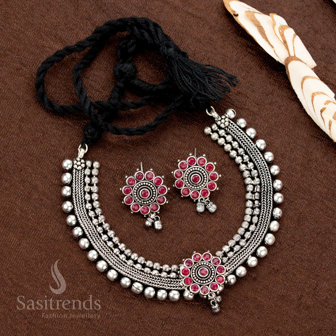 Ruby stone-studded floral choker jewellery set in oxidised silver, designed with four-line beads and matching earrings—ethnic and handcrafted with a statement-making appeal - Sasitrends