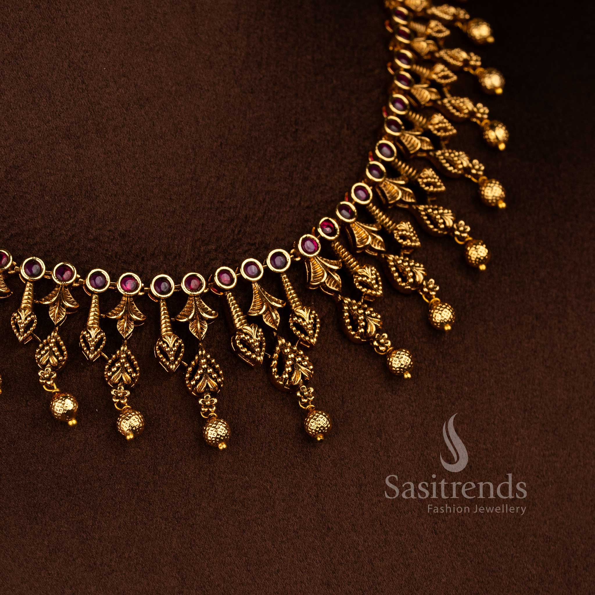 Temple matte gold plated ruby AD stone leaf motif necklace jewellery set featuring circular stone base and multiple hanging bead drops, premium traditional temple jewellery - Sasitrends