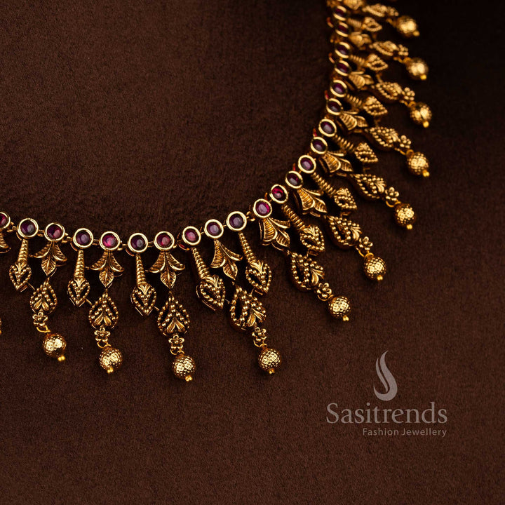 Temple matte gold plated ruby AD stone leaf motif necklace jewellery set featuring circular stone base and multiple hanging bead drops, premium traditional temple jewellery - Sasitrends