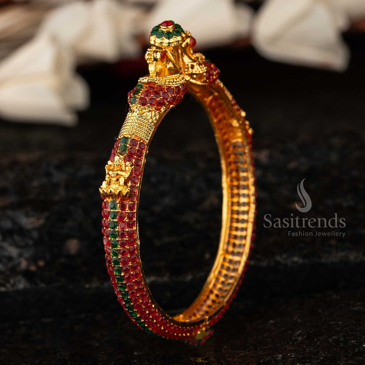Designer micro gold Peacock Lakshmi Kada bangle, artistically adorned with ruby-green stones, a timeless classic ethnic jewellery piece for women - Sasitrends