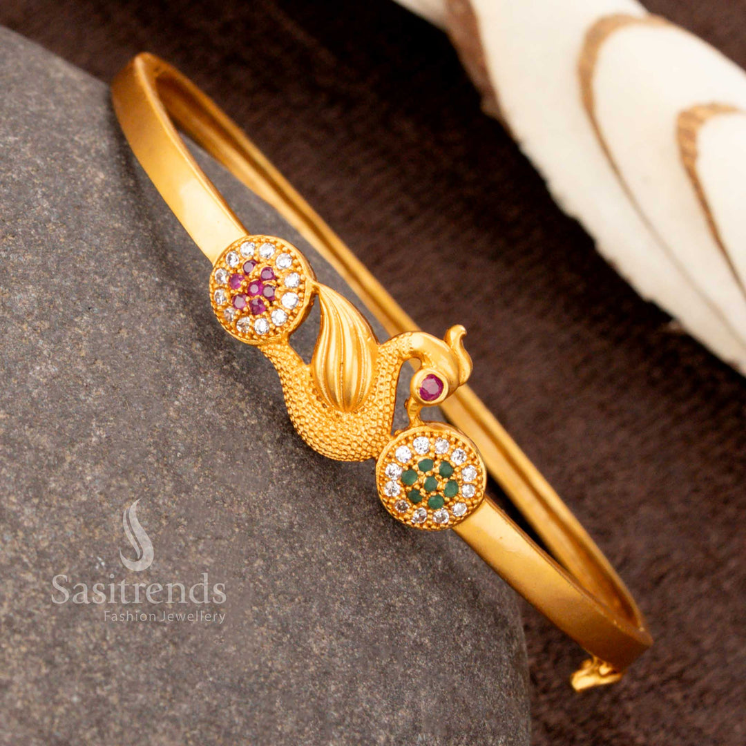 A gorgeous matte gold plated peacock kada bracelet designed with multi-tone AD stones, an exquisite festive jewellery piece - Sasitrends