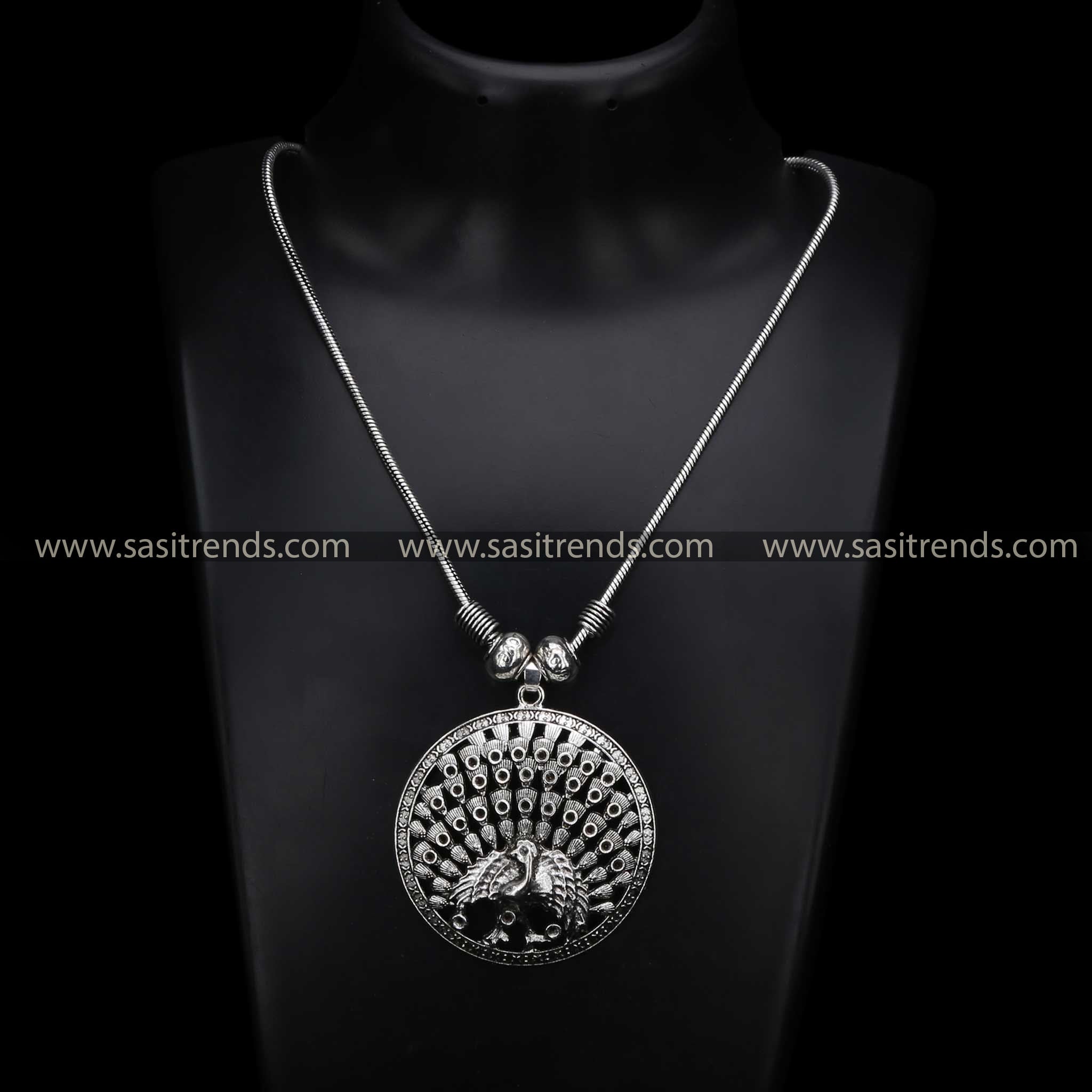Graceful vintage-style oxidised silver necklace featuring a bold full peacock pendant, a fusion jewellery masterpiece blending ethnic charm with Navaratri elegance - Sasitrends