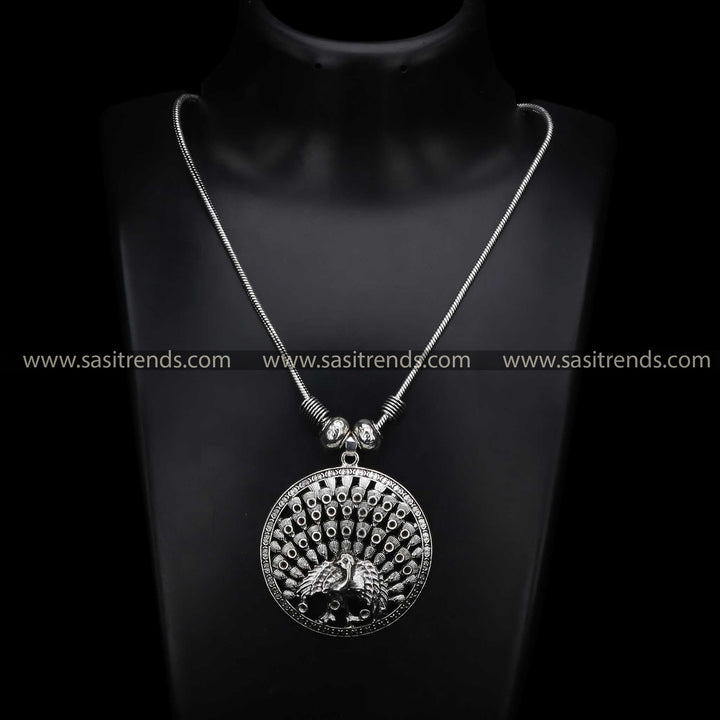 Graceful vintage-style oxidised silver necklace featuring a bold full peacock pendant, a fusion jewellery masterpiece blending ethnic charm with Navaratri elegance - Sasitrends
