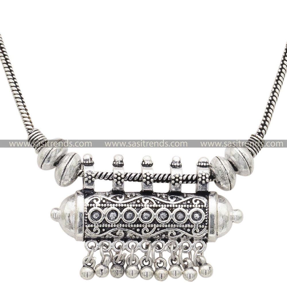 Traditional carved floral pendant on an oxidised silver necklace with spherical beads - Sasitrends