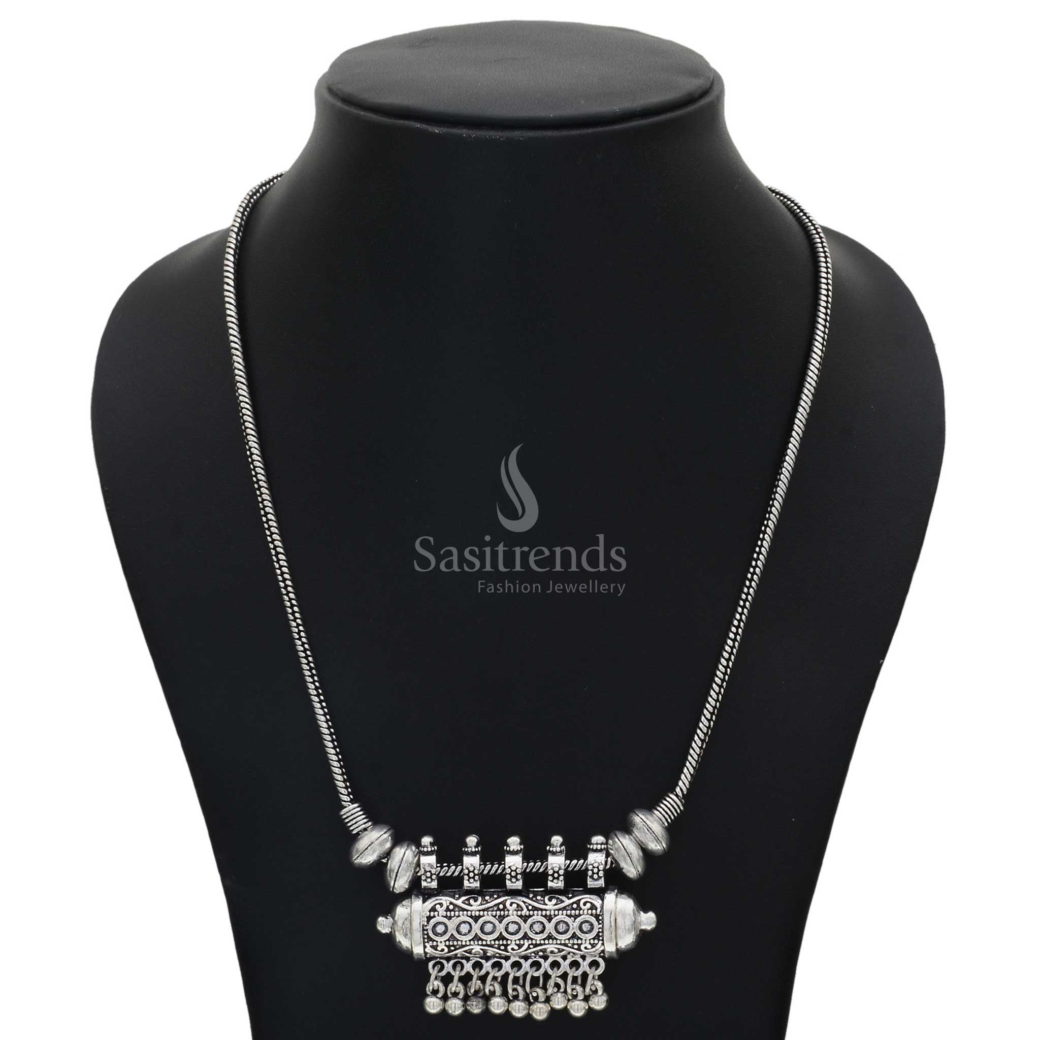 Oxidised silver chain necklace featuring a barrel-shaped tribal pendant with finely engraved antique ball hangings – a rustic ethnic jewellery piece perfect for fusion wear and folk celebrations – Sasitrends