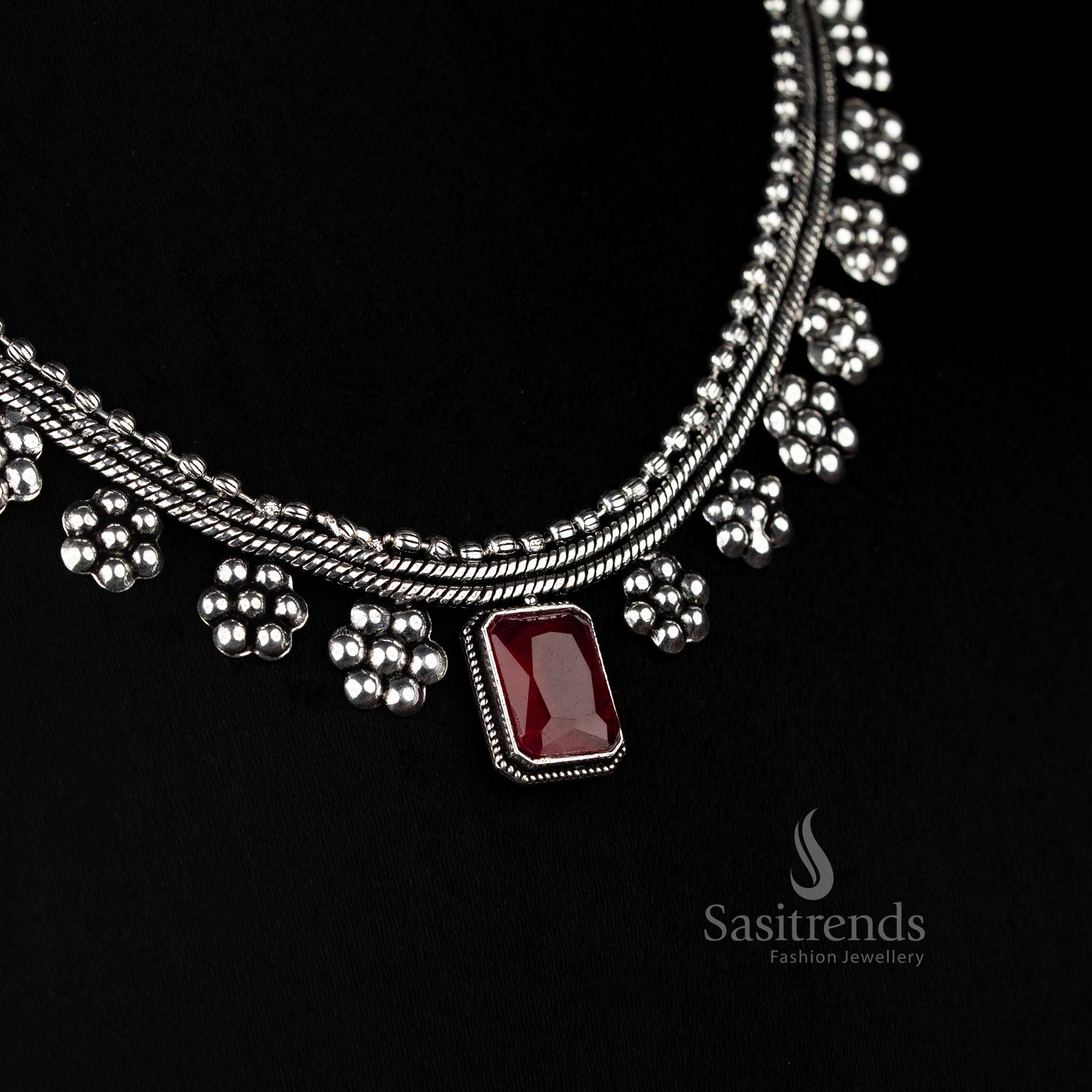 Majesty inspired oxidised silver necklace with ruby rectangular gem and pressed floral design – a standout statement piece by Sasitrends