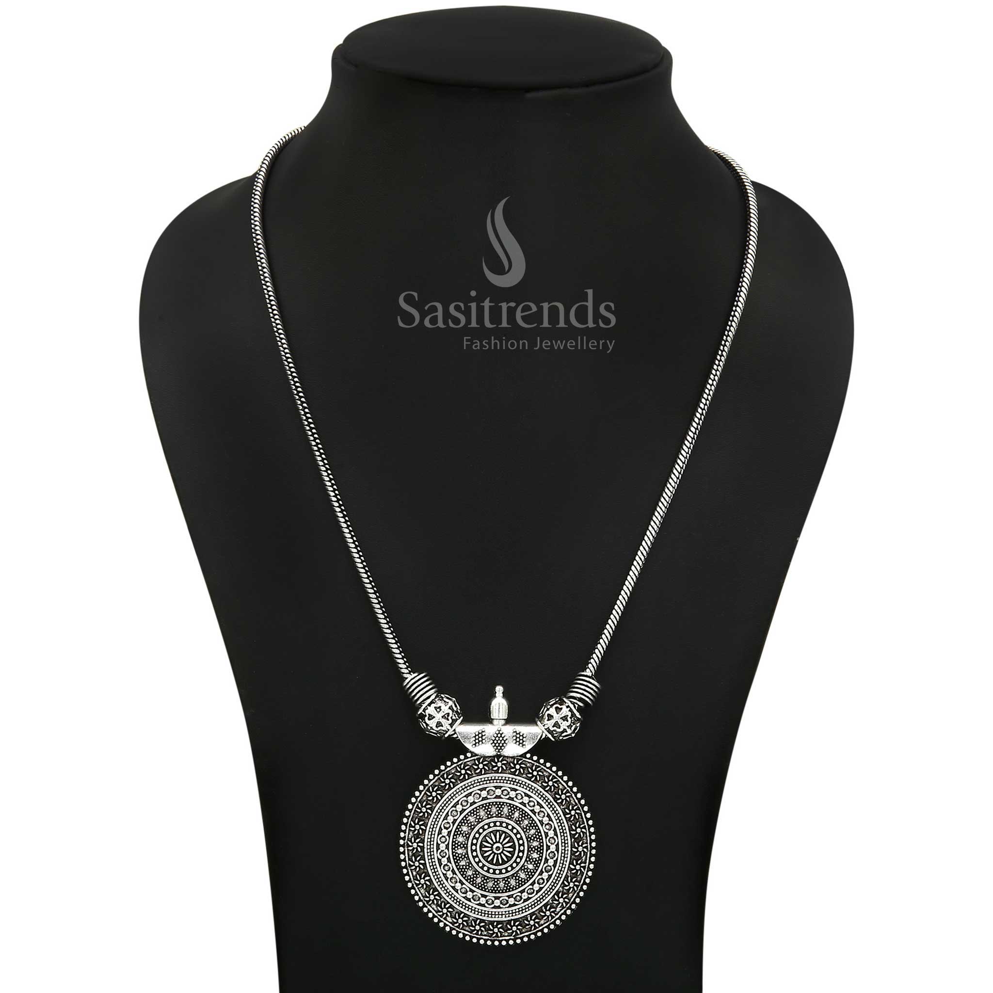 Eternal grace in oxidised silver with the Roopasi necklace, showcasing a round chakra pendant – a fusion of vintage tribal charm and traditional styling for everyday ethnic wear – Sasitrends

