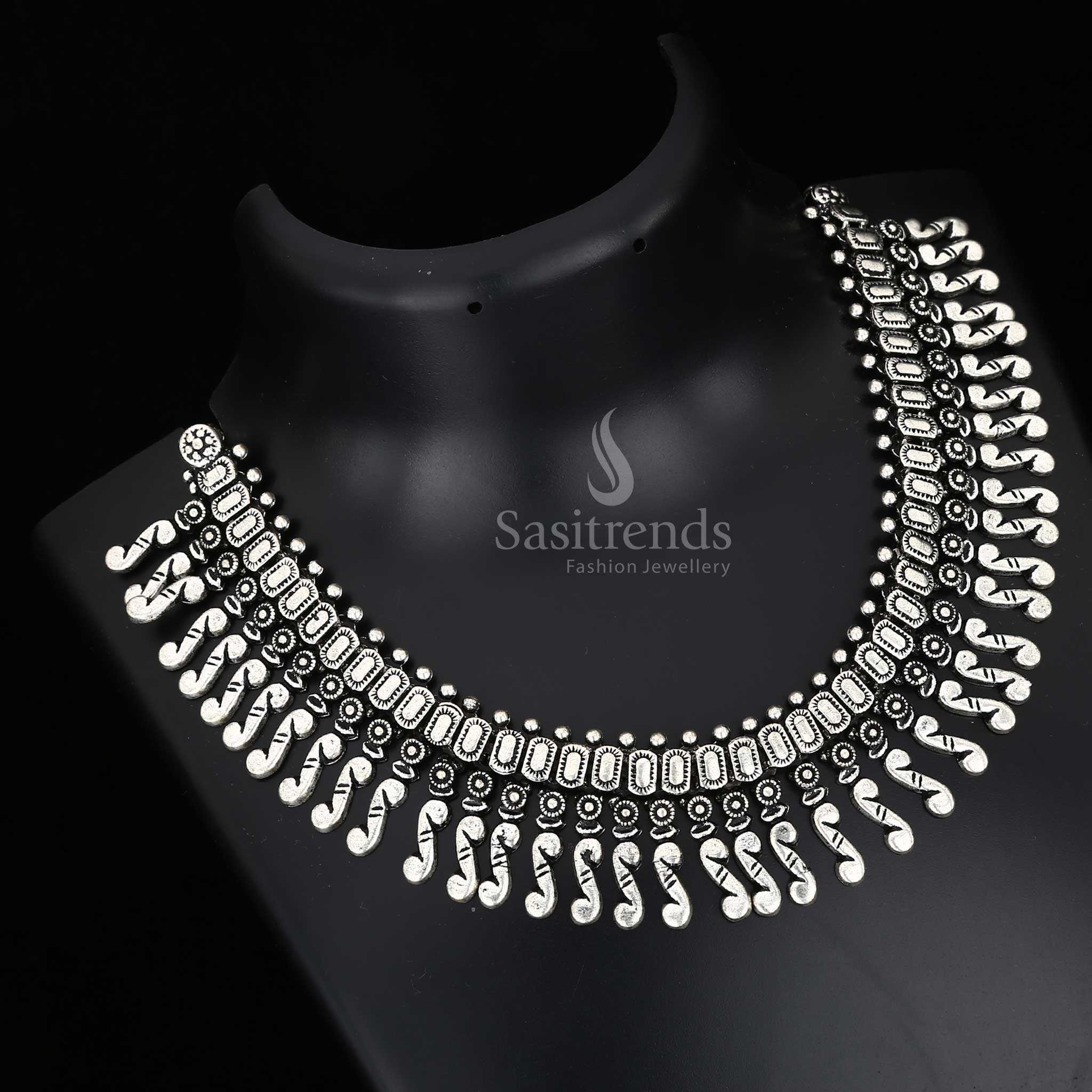 Enchanting roots in every carved detail – a Kolhapuri oxidised tribal necklace with bold central pendant and rustic charm drops, designed for folk jewellery elegance – Sasitrends