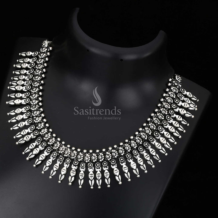 Mystic bloom of cultural grace – this oxidised Kolhapuri necklace with floral pendant and rustic engravings is a classic of folk jewellery tradition – Sasitrends