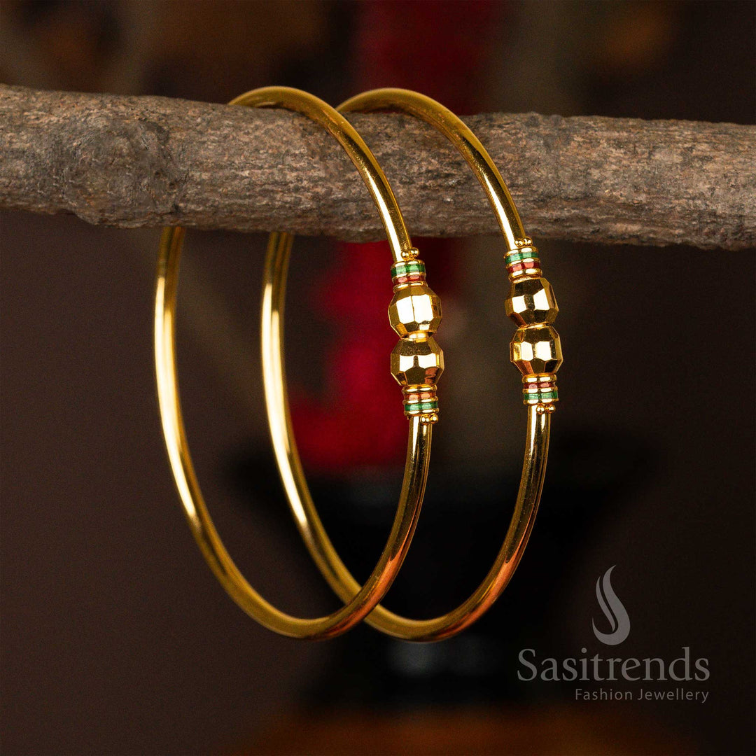 Gold-plated kada bangles with red and green enamelled bead accents