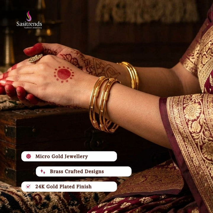 Beautiful collection of micro gold plated bangles styled by a model, elegant traditional jewellery suitable for festive wear, wedding functions, party occasions, and ethnic outfits from Sasitrends.