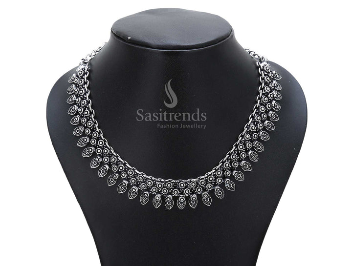 Earthborn heritage defines this oxidised silver necklace with temple bell drops and a beautifully carved lotus motif – a traditional ancestral jewellery piece – Sasitrends