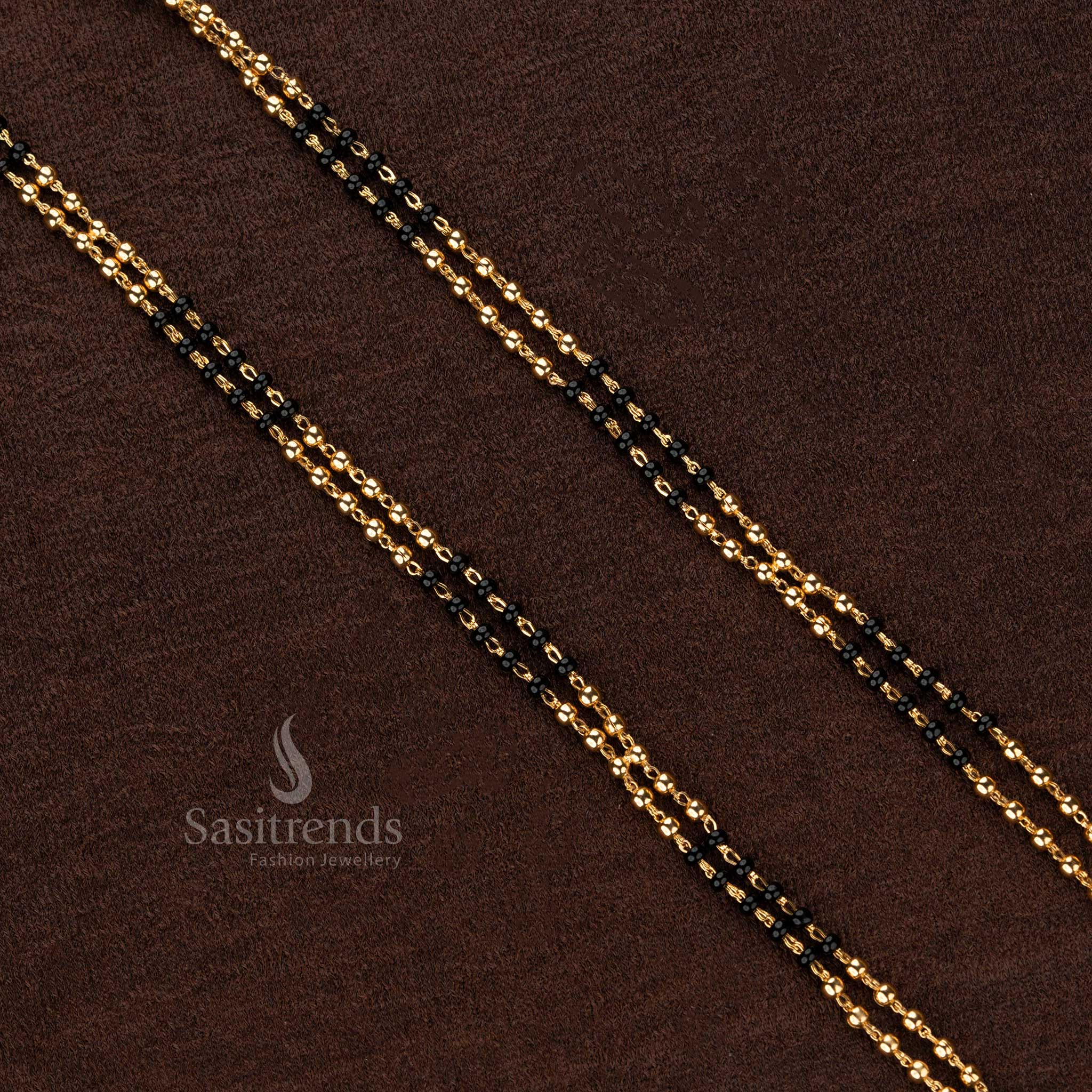 Exquisite double-layered black beaded Thali Saradu chain adorned with shimmering gold beads, crafted for timeless traditional elegance - Sasitrends