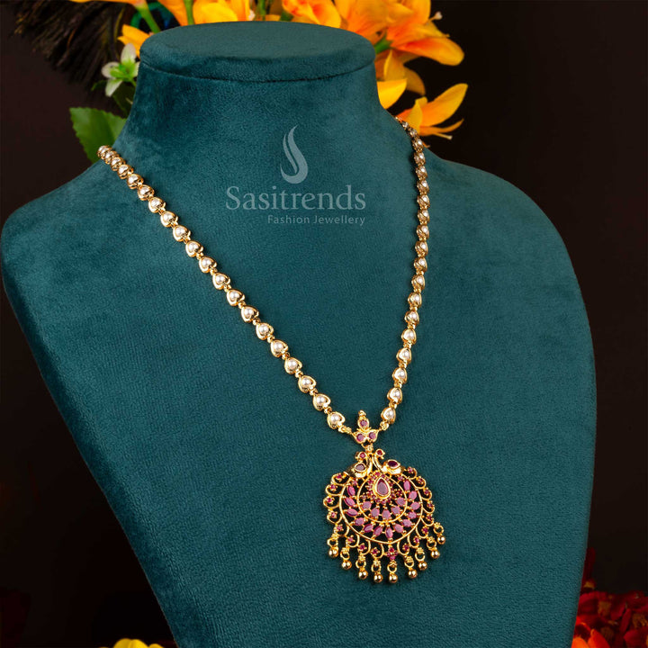 Rich ruby-coloured long necklace with a majestic peacock pendant, micro gold plating, pearl embellishments, and American diamond stones – a regal piece of bridal jewellery – Sasitrends