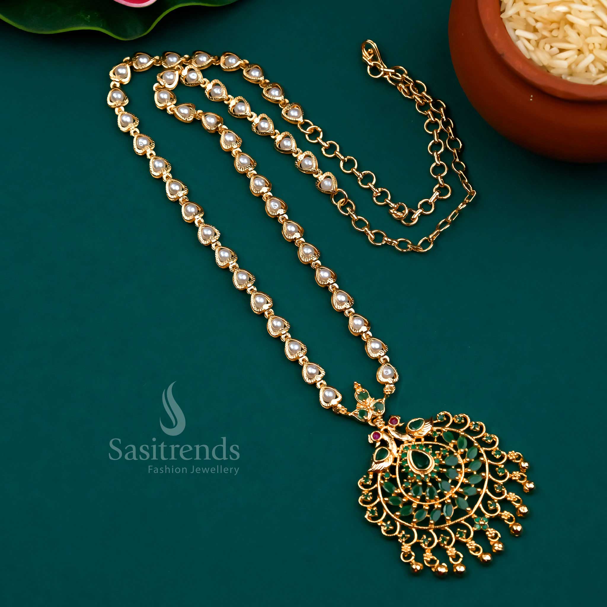 Classic green-ruby colour blend in a peacock pendant design with pearl strands and micro gold finish – a captivating choice for bridal and festive jewellery sets – Sasitrends