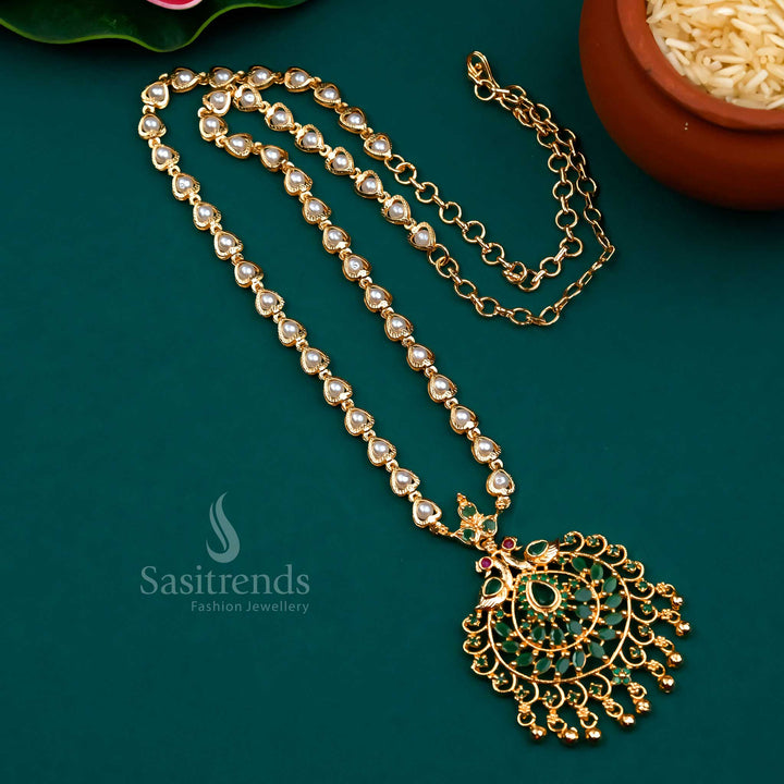 Classic green-ruby colour blend in a peacock pendant design with pearl strands and micro gold finish – a captivating choice for bridal and festive jewellery sets – Sasitrends