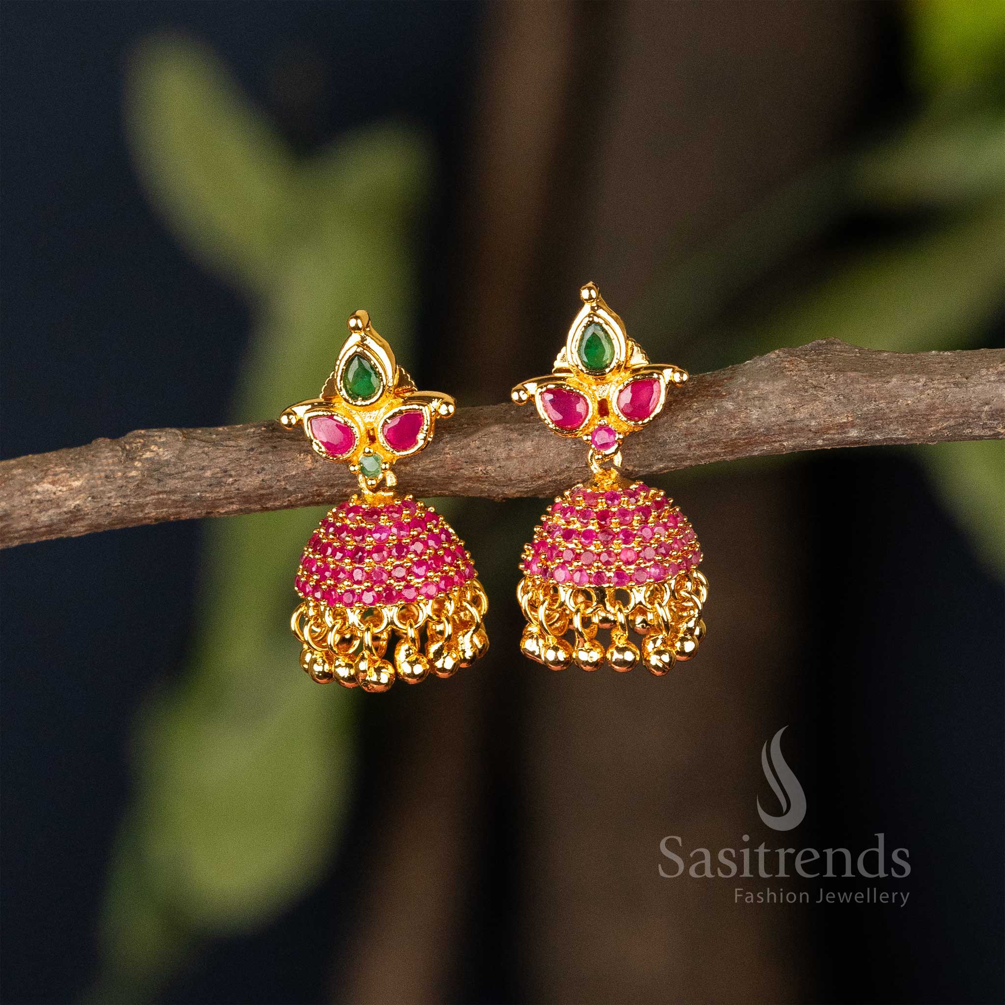 Traditional ruby-green temple Jhumka earrings finished in micro gold plating, adorned with American Diamond highlights and fine filigree – Ethnic grandeur for special occasions – Sasitrends