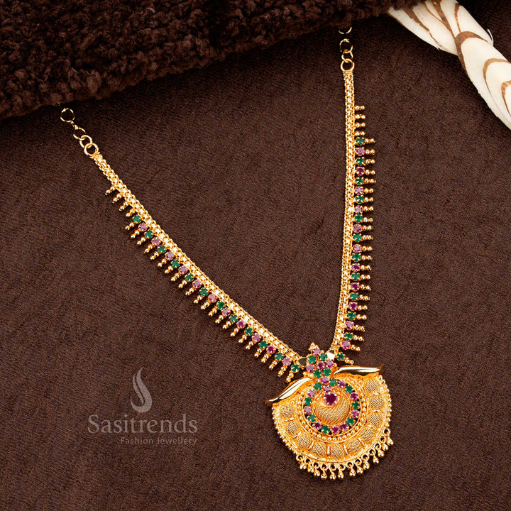 Elegant majestic micro gold plated ruby Green AD tilak pendant royal necklace, designed with sparkling stones and golden ball detailing - Sasitrends