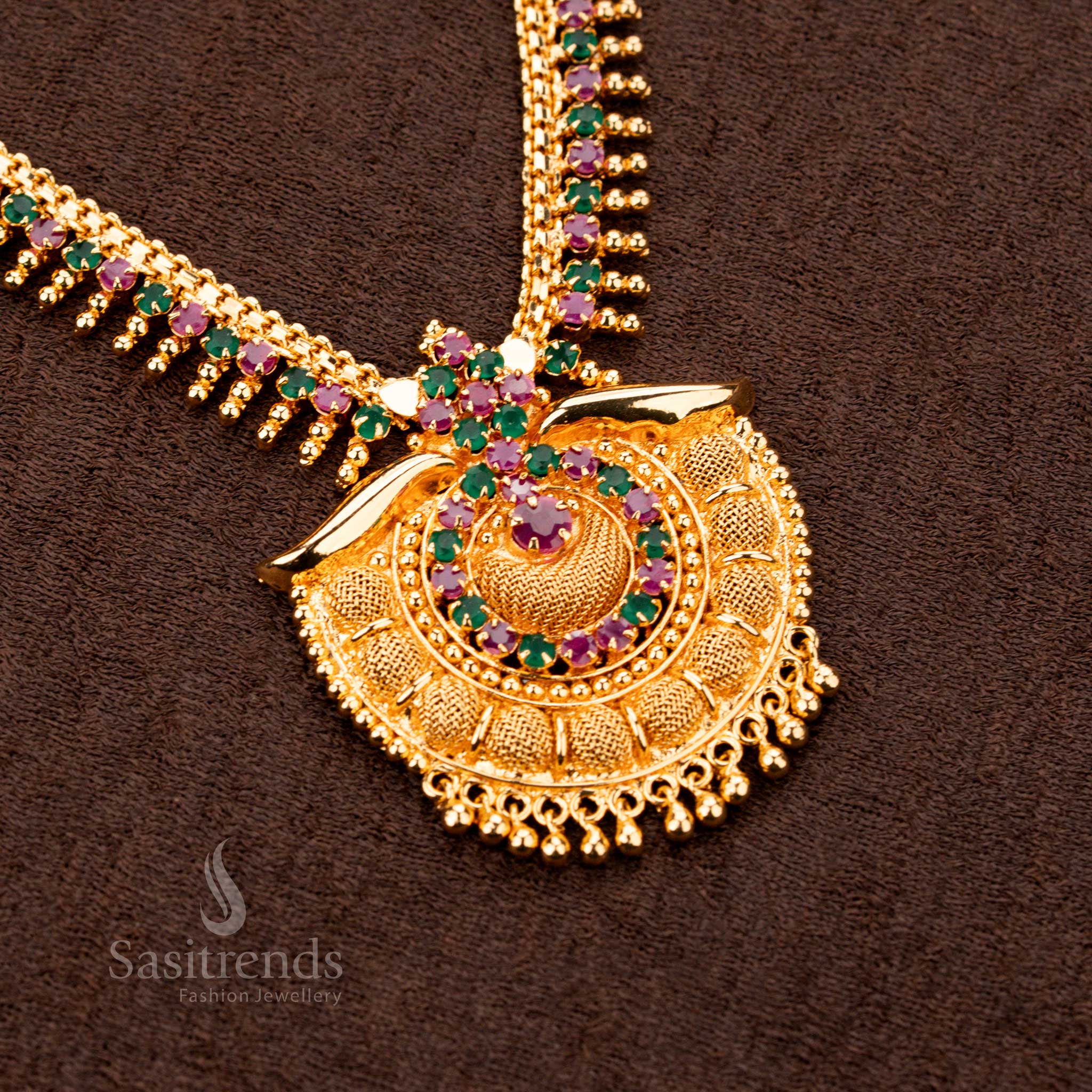 Elegant majestic micro gold plated ruby Green AD tilak pendant royal necklace, designed with sparkling stones and golden ball detailing - Sasitrends