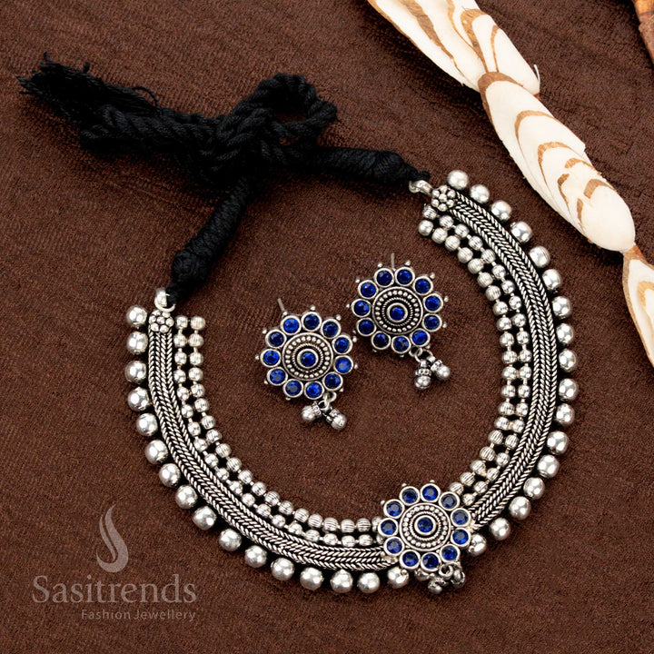 Traditional blue stone choker jewellery set in oxidised German silver, featuring floral motif and ball chain—a vibrant ethnic look with artisan-inspired finish - Sasitrends