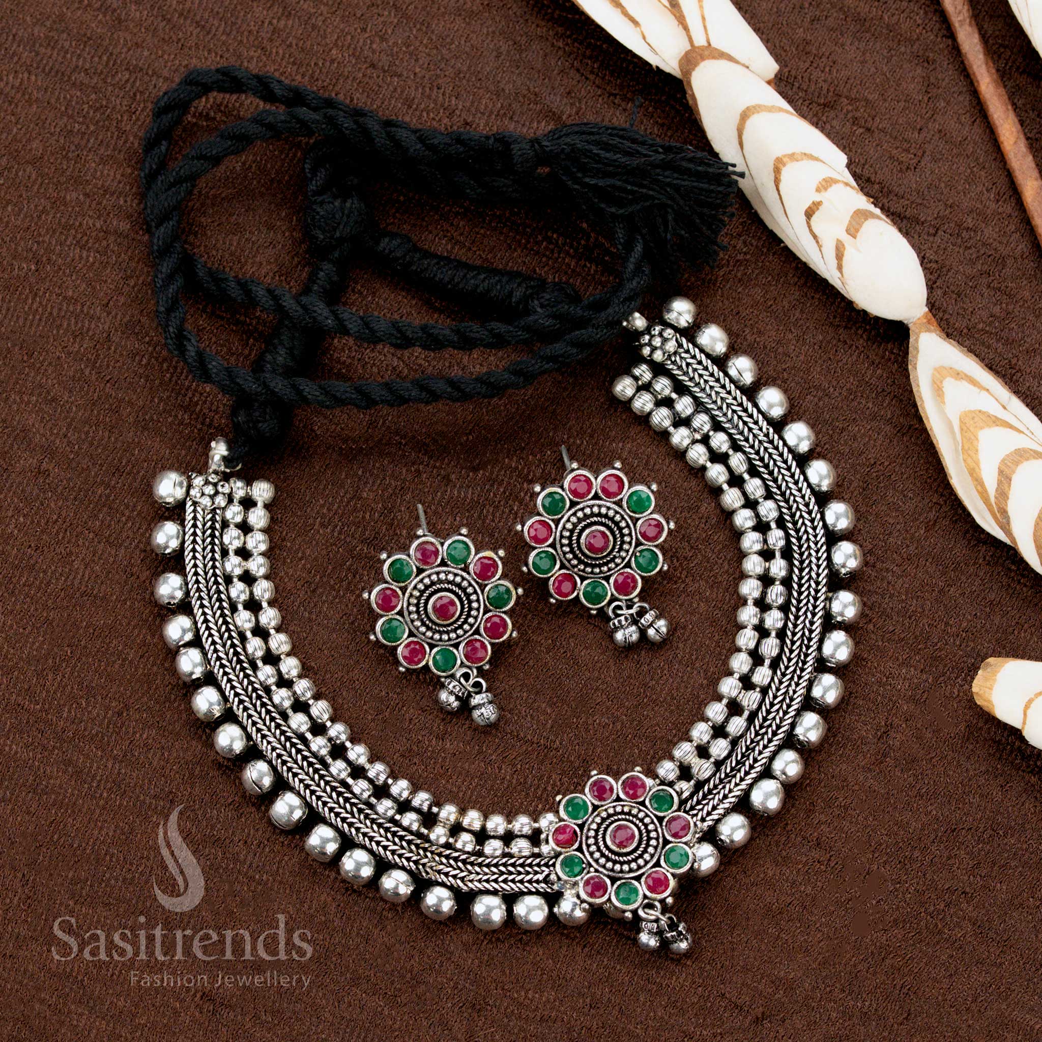 Dual-tone ruby-green studded German silver choker set with floral pendant and earrings—classic traditional jewellery highlighting vibrant hues and timeless artistry - Sasitrends