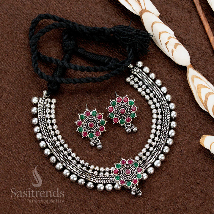 Dual-tone ruby-green studded German silver choker set with floral pendant and earrings—classic traditional jewellery highlighting vibrant hues and timeless artistry - Sasitrends