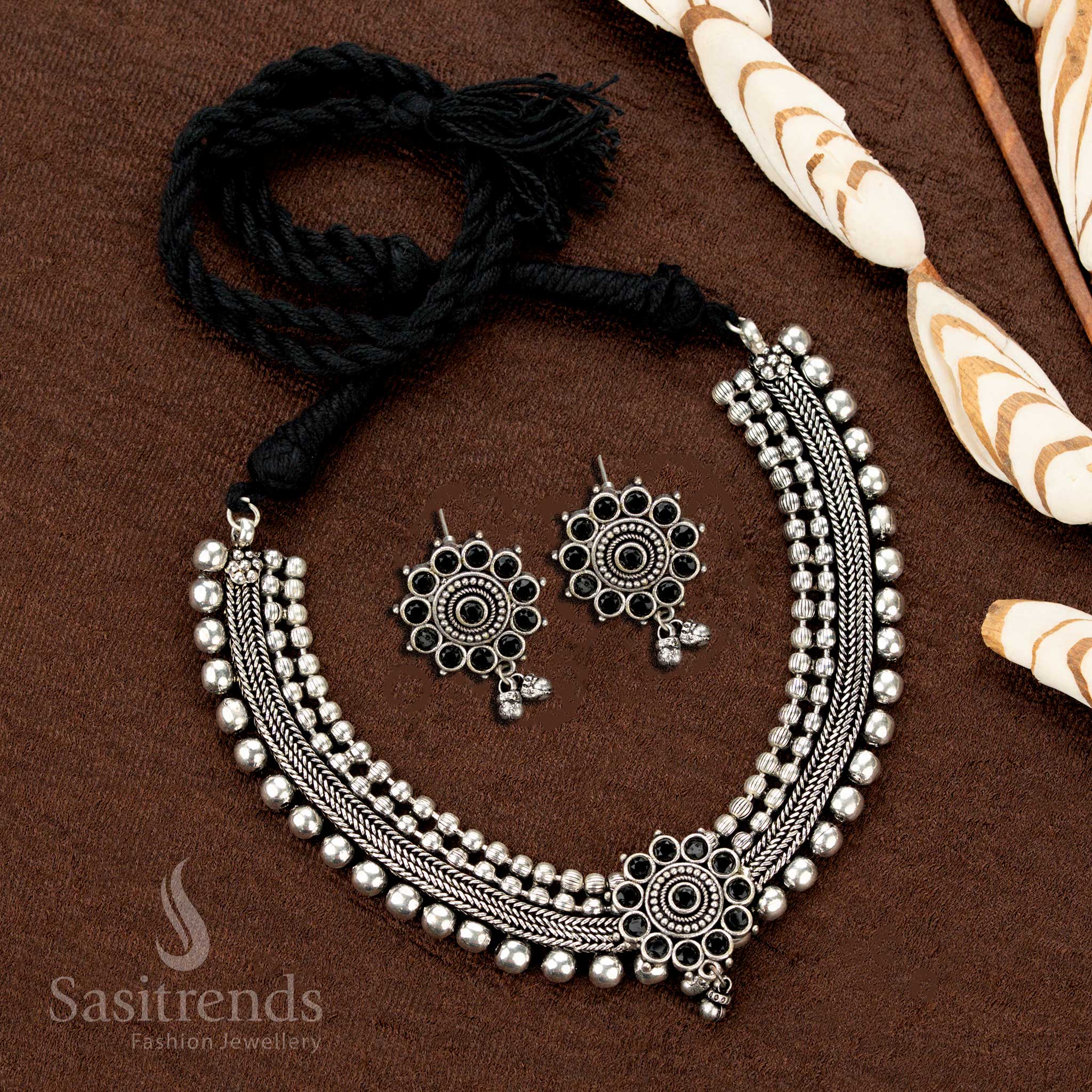Stylish oxidised choker set with black stone floral motif and earrings, designed with four ball layers—a boho chic Indian jewellery ensemble for bold styling - Sasitrends